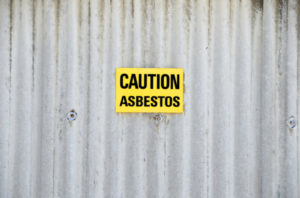 Asbestos Contractor Holmby Hills, CA- caution sign on gate